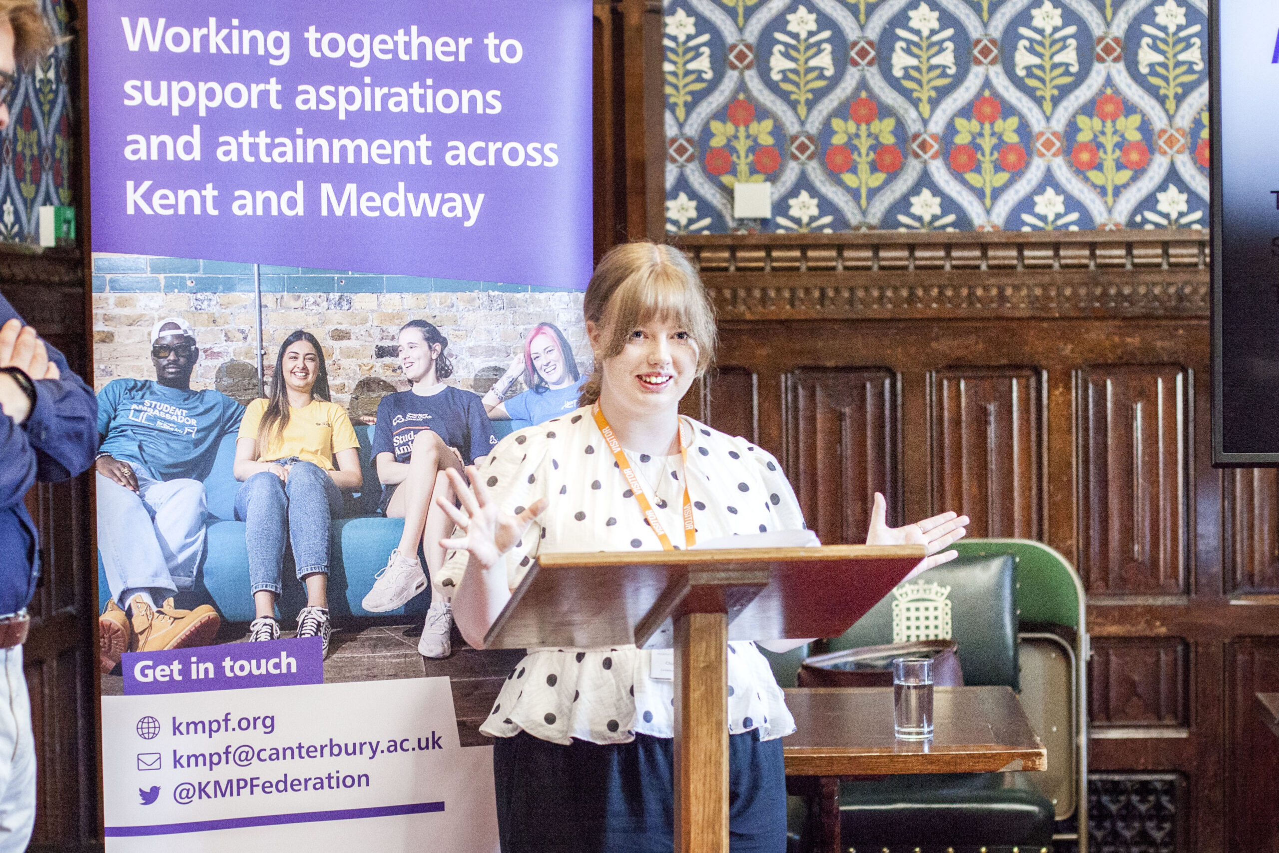 A student stands in front of a lecturn giving a talk